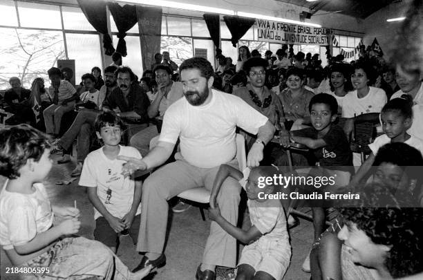 View of Brazilian politician & presidential candidate Luiz Inácio Lula da Silva as he talks with children, during an election campaign event, Duque...