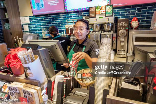 Cozumel, Mexico, Starbucks Coffee Punta Langosta, Avenida Rafael Melgar, barista taking drink order.