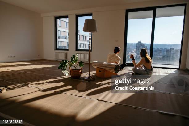 shared moments over coffee in the new place - moving house stock pictures, royalty-free photos & images
