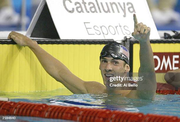 Michael Phelps of the USA celebrates setting a new World Record in the Men's 200m Butterfly Semi-Final during the 10th Fina World Swimming...