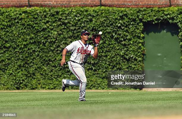 Center fielder Andruw Jones of the Atlanta Braves makes the catch during the game against the Chicago Cubs at Wrigley Field on July 10, 2003 in...