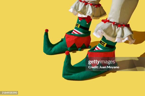 elf wearing red and white socks and green shoes - nymph stock pictures, royalty-free photos & images