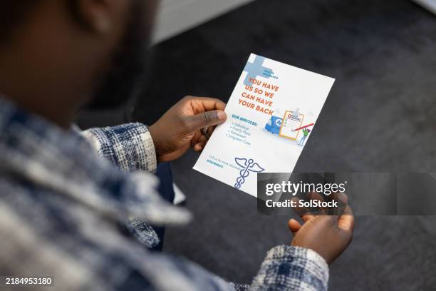 patient holding healthcare leaflet - brochure stock pictures, royalty-free photos & images