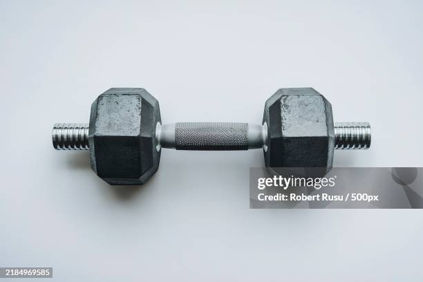 a dumbbell against a white background - lifting heavy objects stock pictures, royalty-free photos & images