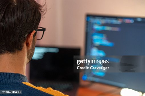 Hispanic Latin computer programmer writes the code software developers working late. Hispanic Latin computer programmer writes the code software developers working late.