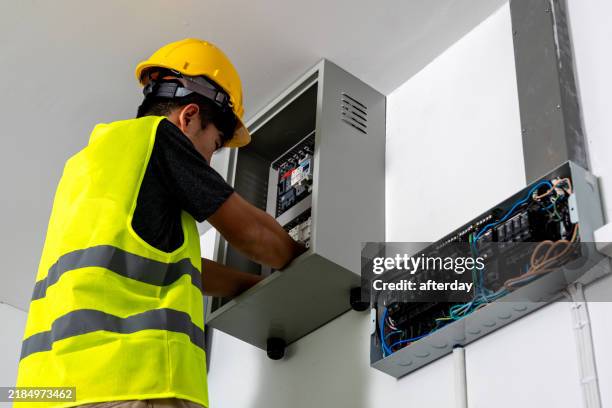 technicians install photovoltaic solar modules on roof of house. engineers install or fix solar cells in roof of house. technician worker on solar panels. solar panel technician working on house roof - generator repair stock pictures, royalty-free photos & images