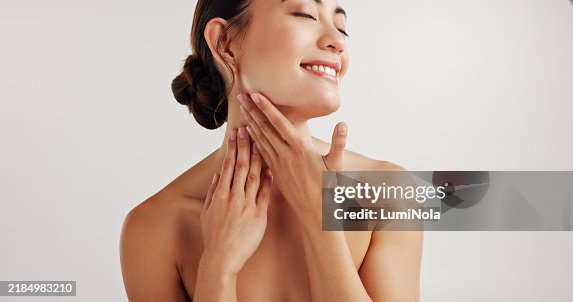Woman, smile and neck for skincare in studio with facial treatment, dermatology and transformation glow. Happy, girl and natural beauty, cosmetic pride and aesthetic mockup space on white background Woman, smile and neck for skincare in studio with facial treatment, dermatology and transformation glow. Happy, girl and natural beauty, cosmetic pride and aesthetic mockup space on white background