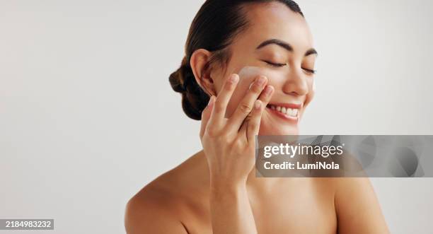 woman, facial skin and lotion in studio for touch, happy and benefits by white background. person, model and cosmetic cream with mock up space, beauty and serum for transformation with eyes closed - moisturiser stock pictures, royalty-free photos & images