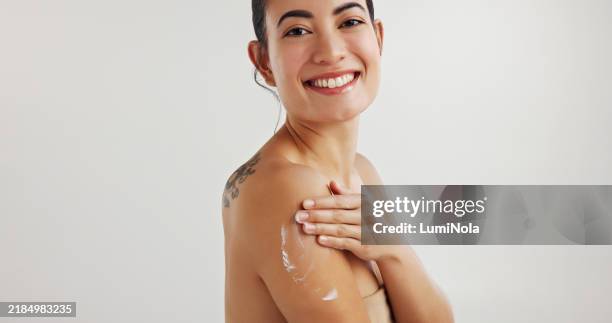 studio, woman and portrait with lotion for skincare, treatment and cosmetics product for wellness. mockup space, female person and hands with application for body cream, beauty and white background - creme corporal imagens e fotografias de stock