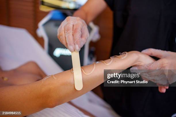 arm laser treatment in a spa setting - bare feet office stock pictures, royalty-free photos & images