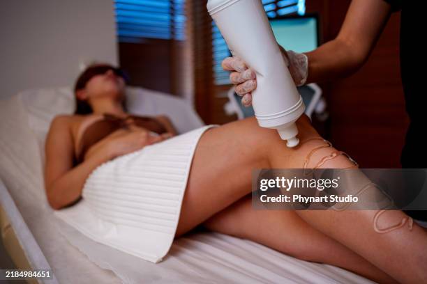leg laser treatment in a spa setting - bare feet office stock pictures, royalty-free photos & images