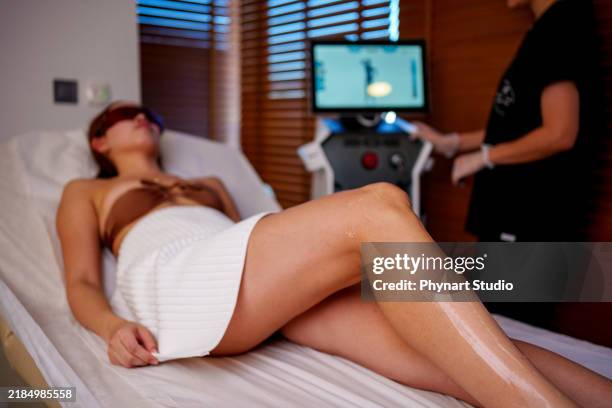 leg laser treatment in a spa setting - bare feet office stock pictures, royalty-free photos & images