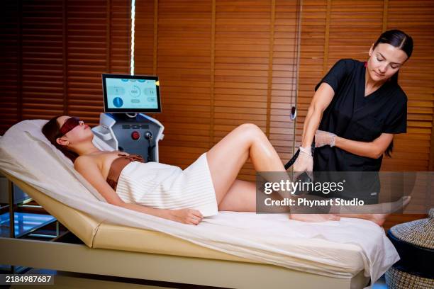leg laser treatment in a spa setting - bare feet office stock pictures, royalty-free photos & images