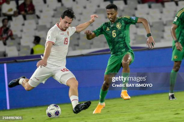 Saudi Arabia's Nasser Al Dawsari fights for the ball with Indonesia's Thom Haye during the 2026 World Cup Asian qualification football match at Bung...