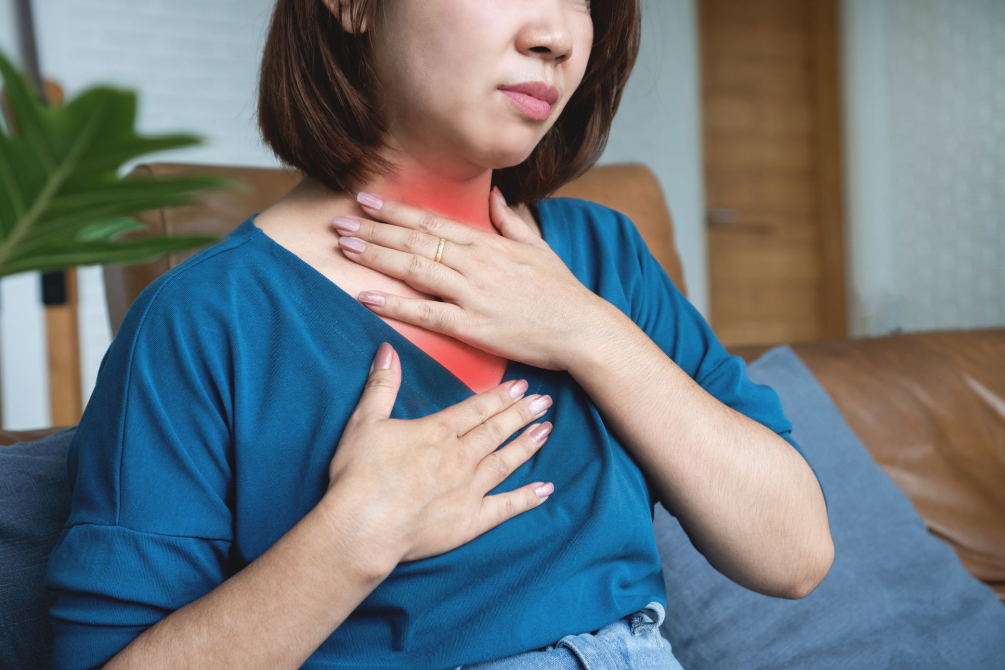 Asian woman suffering from gastroesophageal reflux disease feeling sore throat Asian woman suffering from gastroesophageal reflux disease feeling sore throat