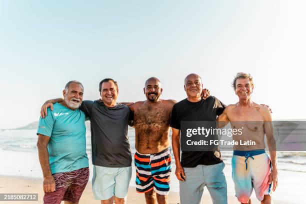 portrait of senior friends men on the beach - modern manhood stock pictures, royalty-free photos & images