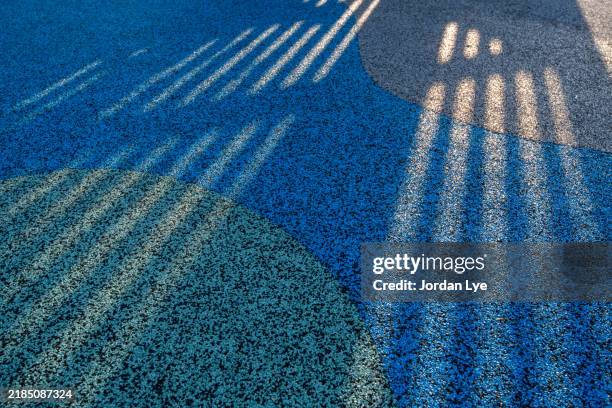 shadow on granulated rubber floor surface - rubber material stock pictures, royalty-free photos & images