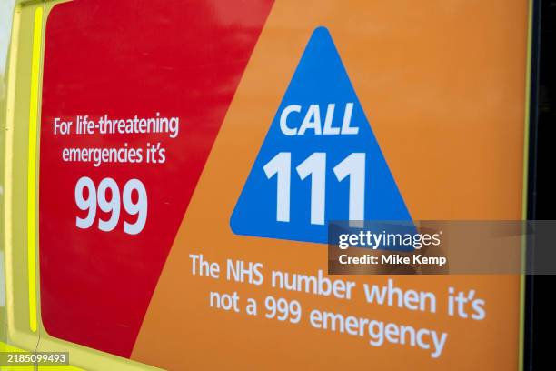 Advice on the side of an NHS ambulance for patients in an emergency to call 999 on their phone, or if it is not an emergency situation to dial 111 on...