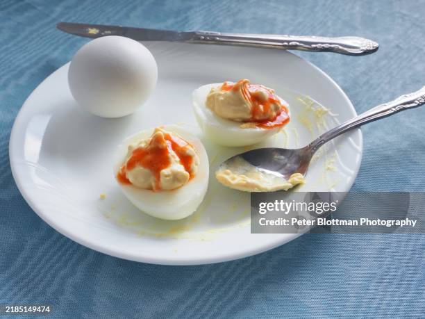 spicy deviled eggs prepared on plate - deviled egg stock pictures, royalty-free photos & images