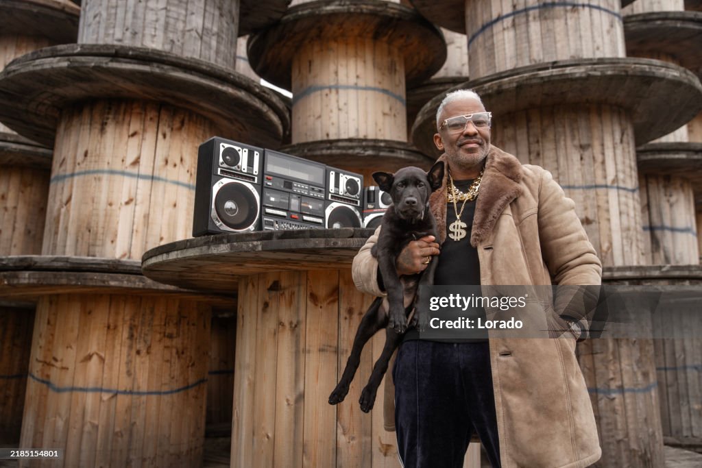 1980s style Handsome black man with a puppy in an urban setting