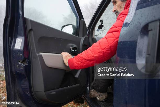 winter adventure. man enters vehicle after scenic outdoor hike - car door stock pictures, royalty-free photos & images