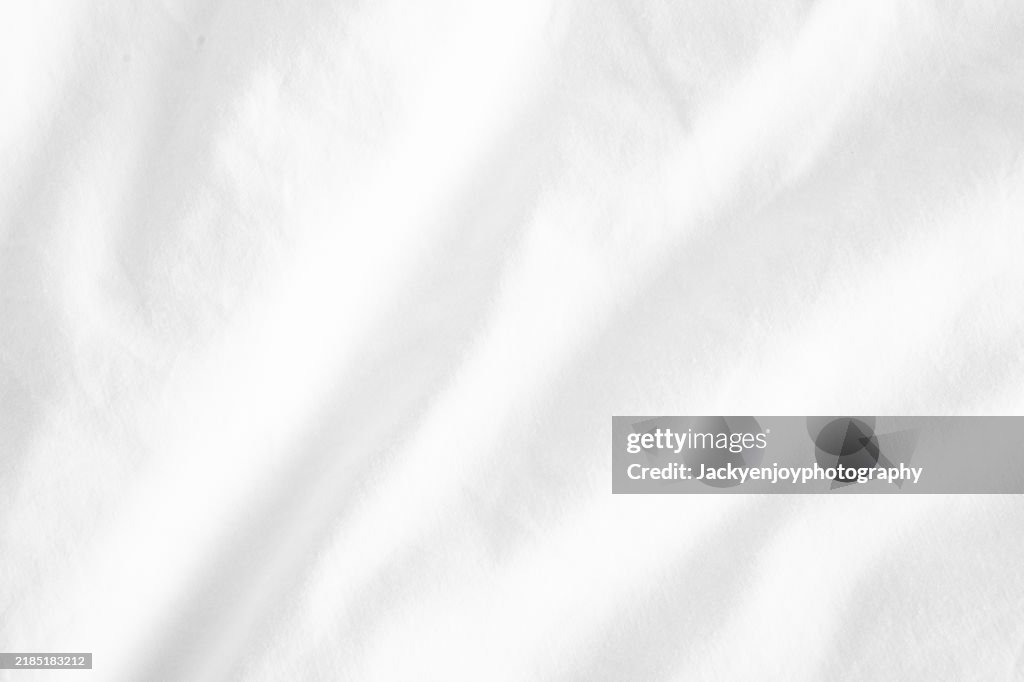 Polyester fabric with a white colour and a textile backdrop.