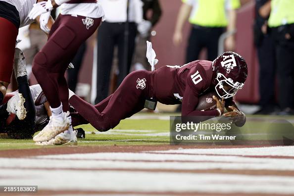 Marcel Reed Dancing Marcel Reed of the Texas A&M Aggies dives into the end zone for a ...
