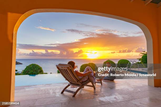 cheerful man and woman relaxing in a luxury resort - överklass bildbanksfoton och bilder