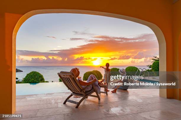 happy family watching sunset in a luxury villa - överklass bildbanksfoton och bilder