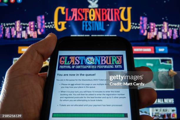 In this photo illustration a man holds a smart phone which shows the See Tickets web page on November 17, 2024 in Glastonbury, England. Tickets for...