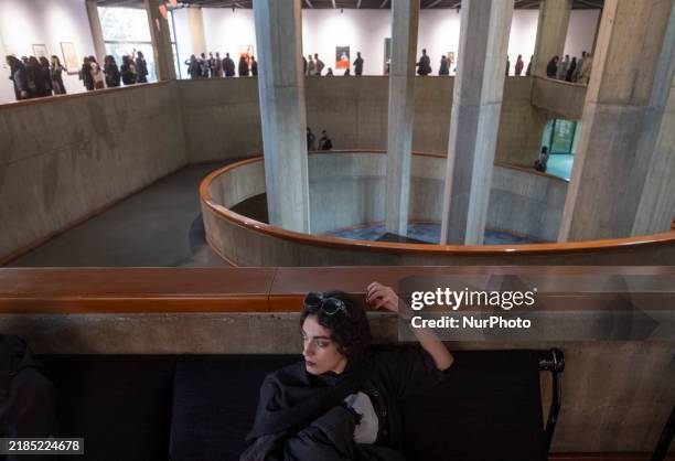 Young Iranian woman rests while people explore the ''Eye to Eye, Portraiture in Modern and Contemporary Art'' exhibition at the Museum of...