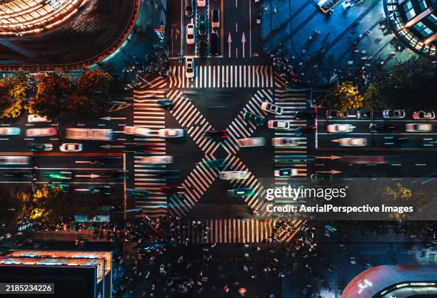 aerial view of crossroad and city traffic at night - incrocio stradale foto e immagini stock