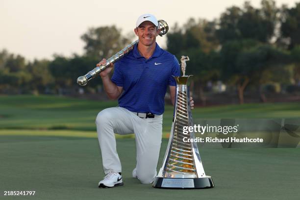 Rory McIlroy of Northern Ireland poses with the DP World Tour Championship trophy and the Race to Dubai trophy on the 18th green, on day four of the...