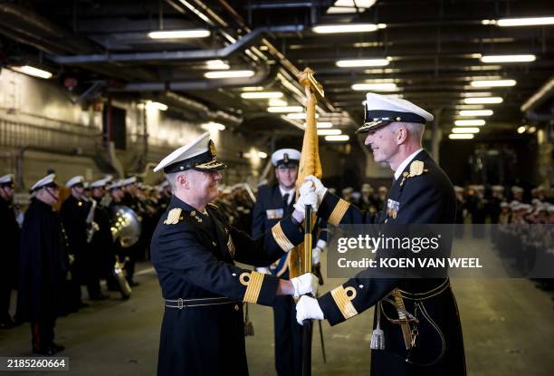 Commander George Pastoor receives from rank mate Arjen Warnaar the squadron banner with which he accepts command of the Dutch fleet, in Den Helder on...