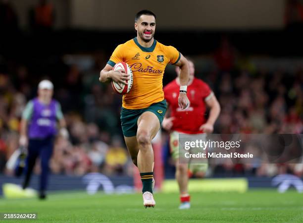 Tom Wright of Australia runs in to score his team's sixth try during the Autumn Nations Series 2024 match between Wales and Australia at the...