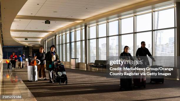 November 21: Travelers arrive at John Wayne Airport in Santa Ana, CA on Thursday, November 21, 2024. The American Automobile Association predicts the...