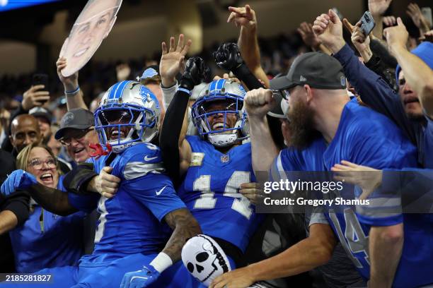 Amon-Ra St. Brown of the Detroit Lions celebrates with fans after scoring a touchdown in the fourth quarter of a game against the Jacksonville...