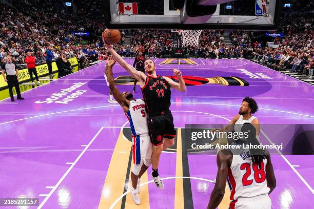 Jakob Poeltl of the Toronto Raptors reaches for the rebound against Malik Beasley of the Detroit Pistons during the Emirates NBA Cup game at...