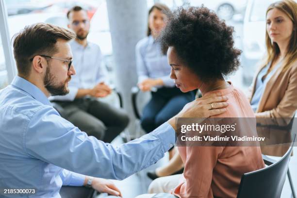 man consoling woman in a psychological circle - emotional intelligence stock pictures, royalty-free photos & images