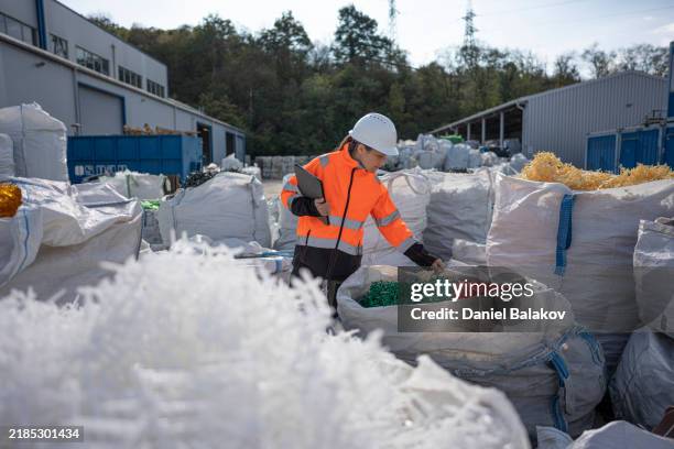 worker checks plastic resins ready for reuse in manufacturing - waste management stock pictures, royalty-free photos & images