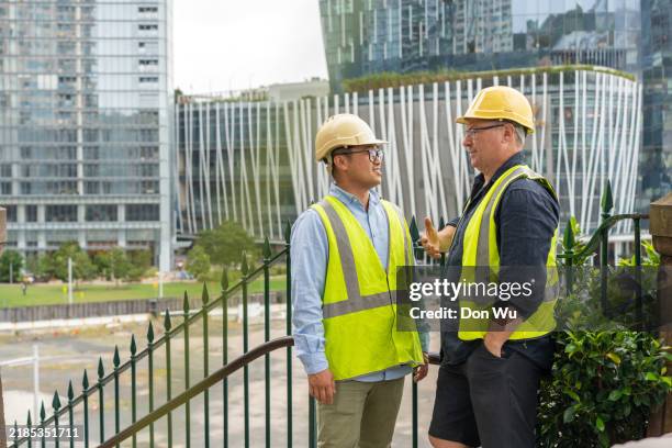 two male project managers in an urban city - real estate developer stock pictures, royalty-free photos & images