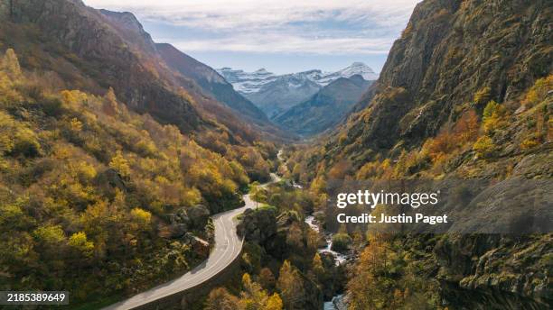 a drone point of view of a beautiful autumnal valley in the french pyrenees mountains - pyrenees stock pictures, royalty-free photos & images
