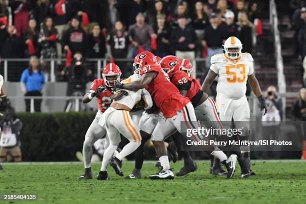 Warren Brinson of the Georgia Bulldogs tackles Peyton Lewis pod the Tennessee Volunteers during a game between University of Tennessee and University...