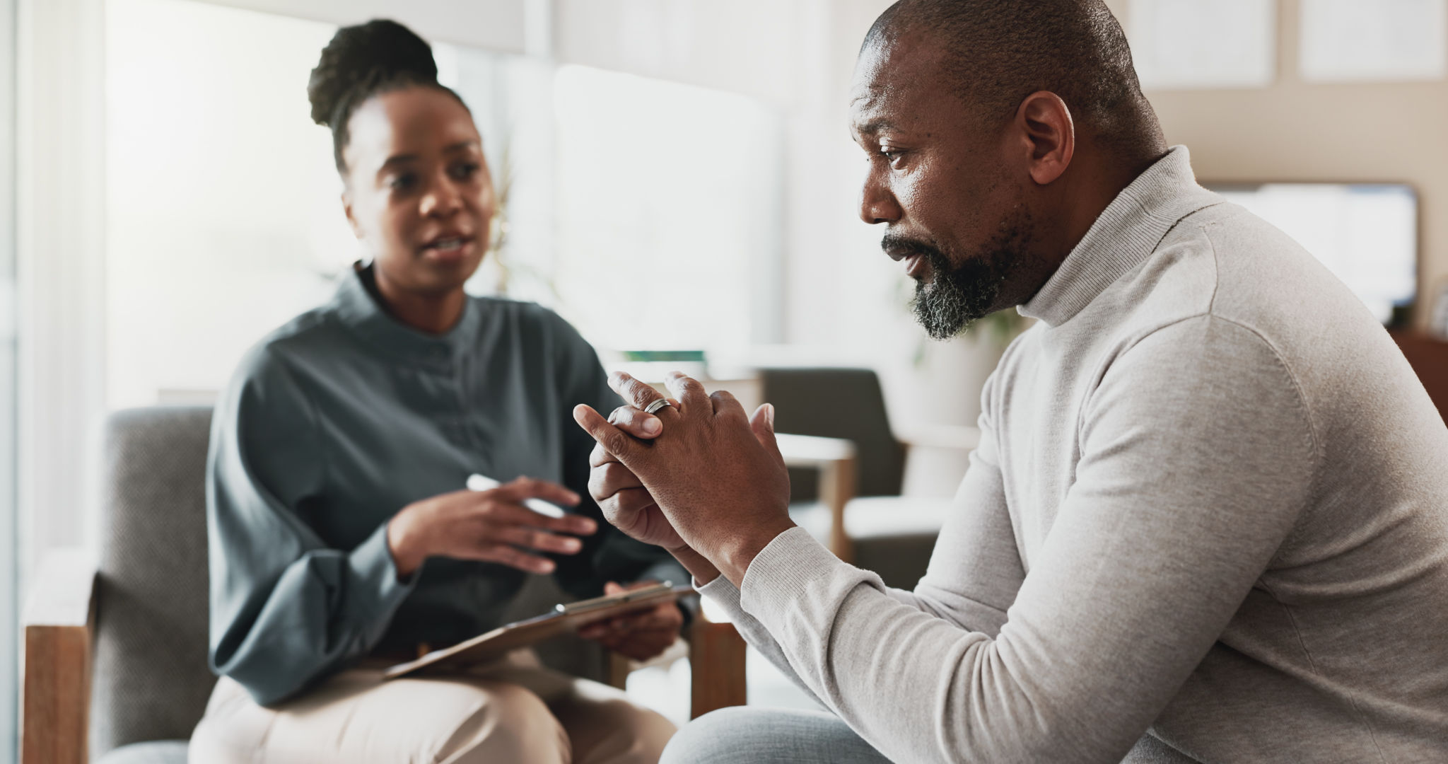 Psychology, therapist and talking in office with patient, discussion and advice for mental health. Black people, therapy and notes in consultation for separation anxiety, mistake or doubt in marriage Psychology, therapist and talking in office with patient, discussion and advice for mental health. Black people, therapy and notes in consultation for separation anxiety, mistake or doubt in marriage