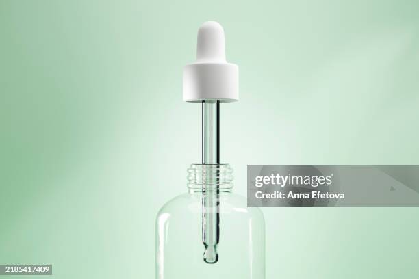glass pipette with white dropper over blue background with shadows. cgi - botella con gotero fotografías e imágenes de stock