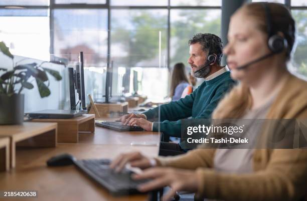 professional caucasian man with headset working on desktop pc - task manager stock pictures, royalty-free photos & images