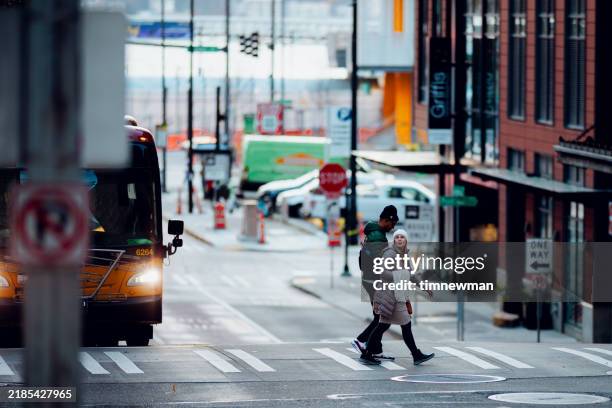 pedestrian crosswalk busy streets in downtown seattle - seattle winter stock pictures, royalty-free photos & images
