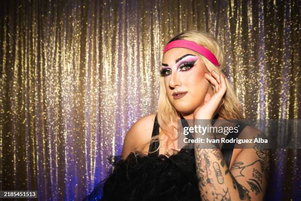 drag queen posing with hand on face and shiny background - cross dressing stock pictures, royalty-free photos & images