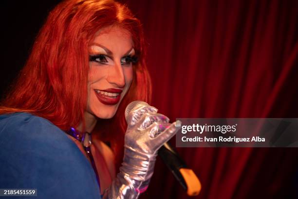 drag queen singing with microphone and silver gloves on stage - cabaret stock pictures, royalty-free photos & images