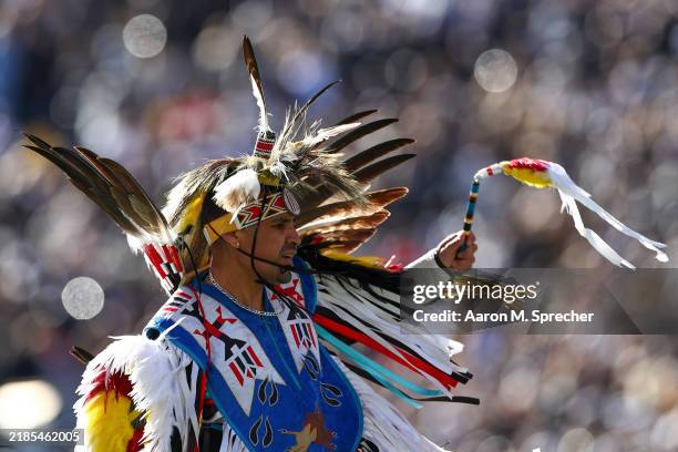 Member of the Wind River Indian Reservation performs a tradition dance in a timeout during the first half at Folsom Field on November 16, 2024 in...
